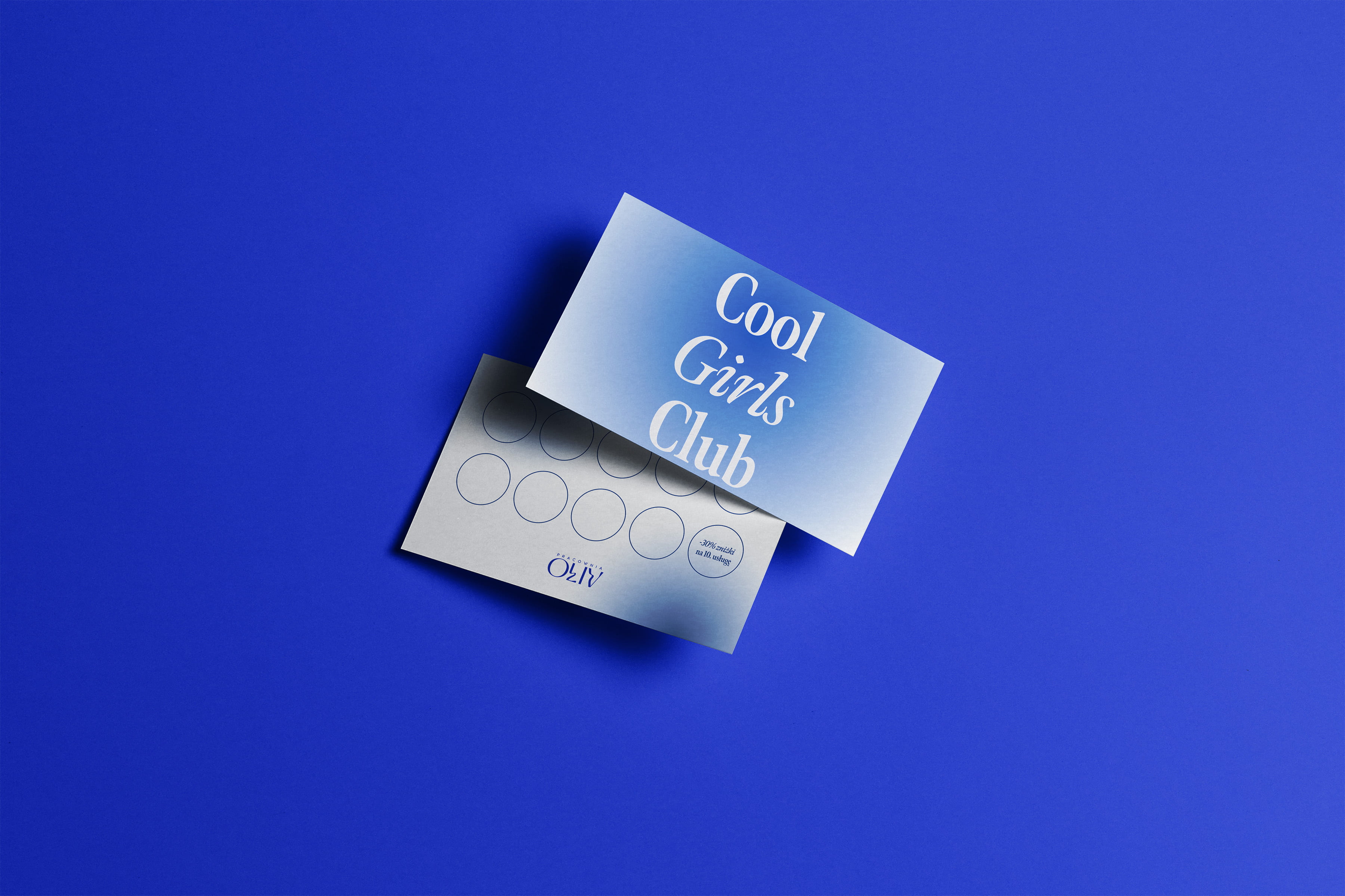 Loyalty card with 'Cool Girls Club' in gradient blue and white, placed on a bold blue background.