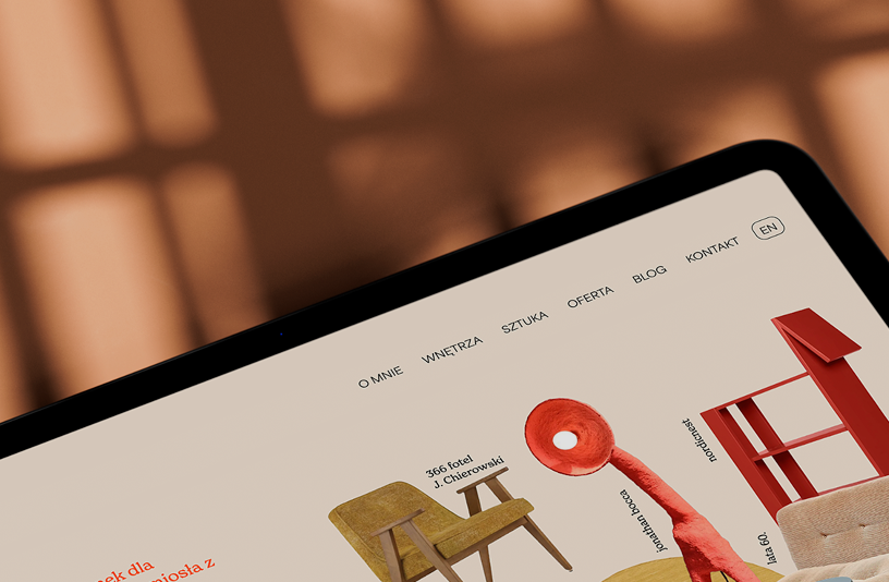 a tablet laid on a wooden table top, presenting a landing page of Heiduk studio