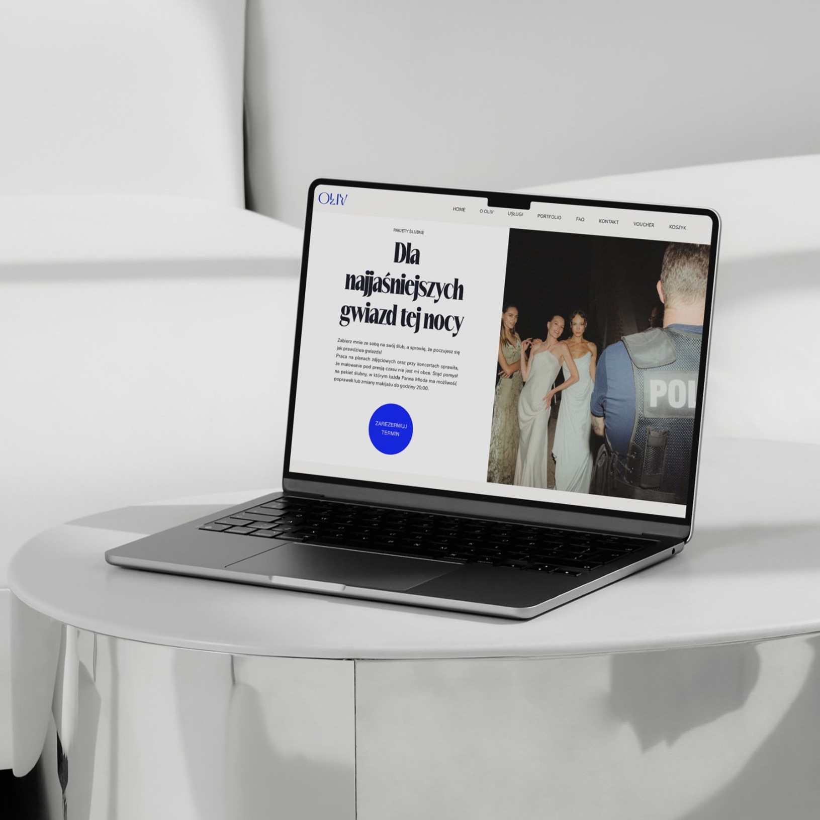 Open laptop on a sleek table, displaying a makeup artist’s website with bold text and an event photo.