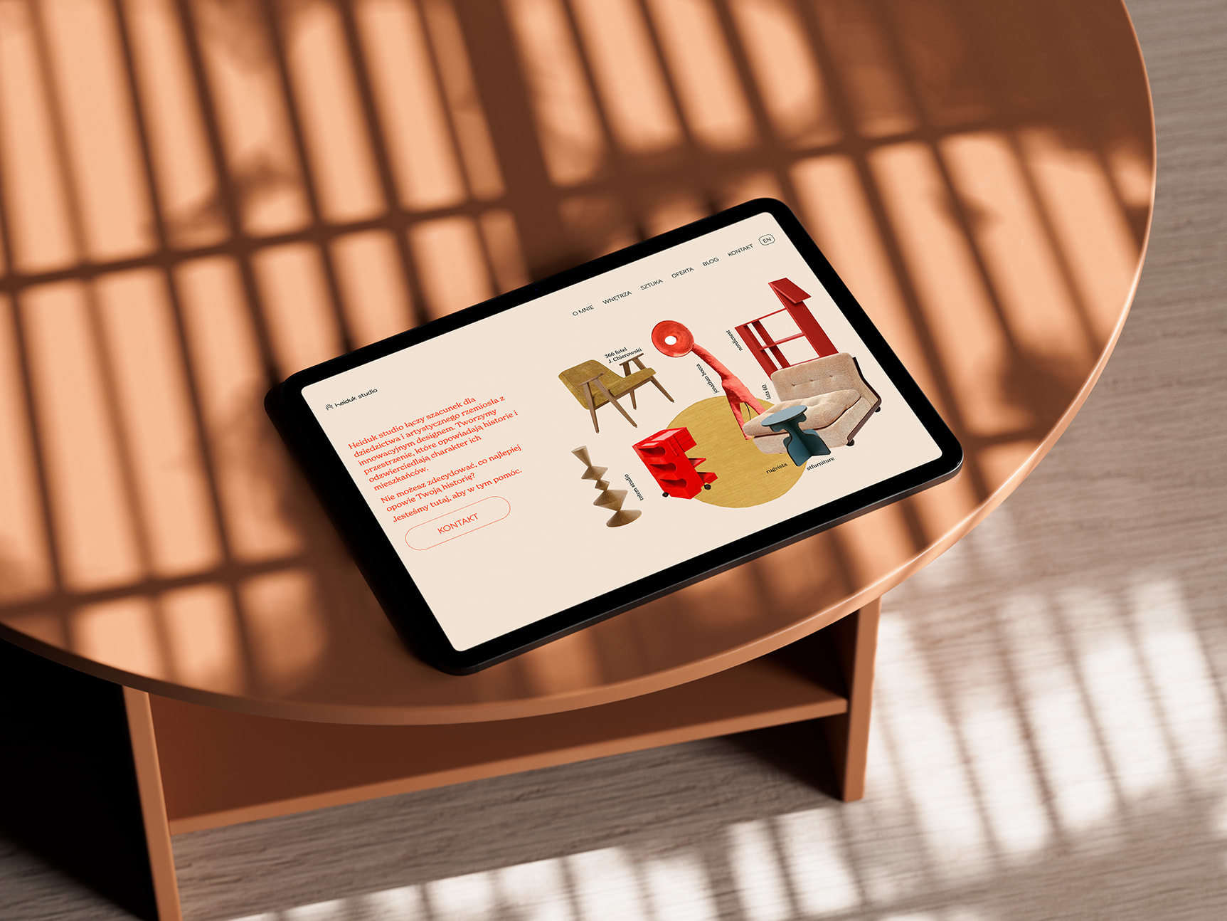 a tablet laid on a wooden table top, presenting a landing page of Heiduk studio